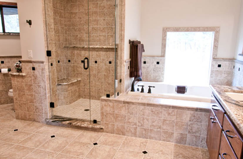 A bathroom with a tub and shower in it