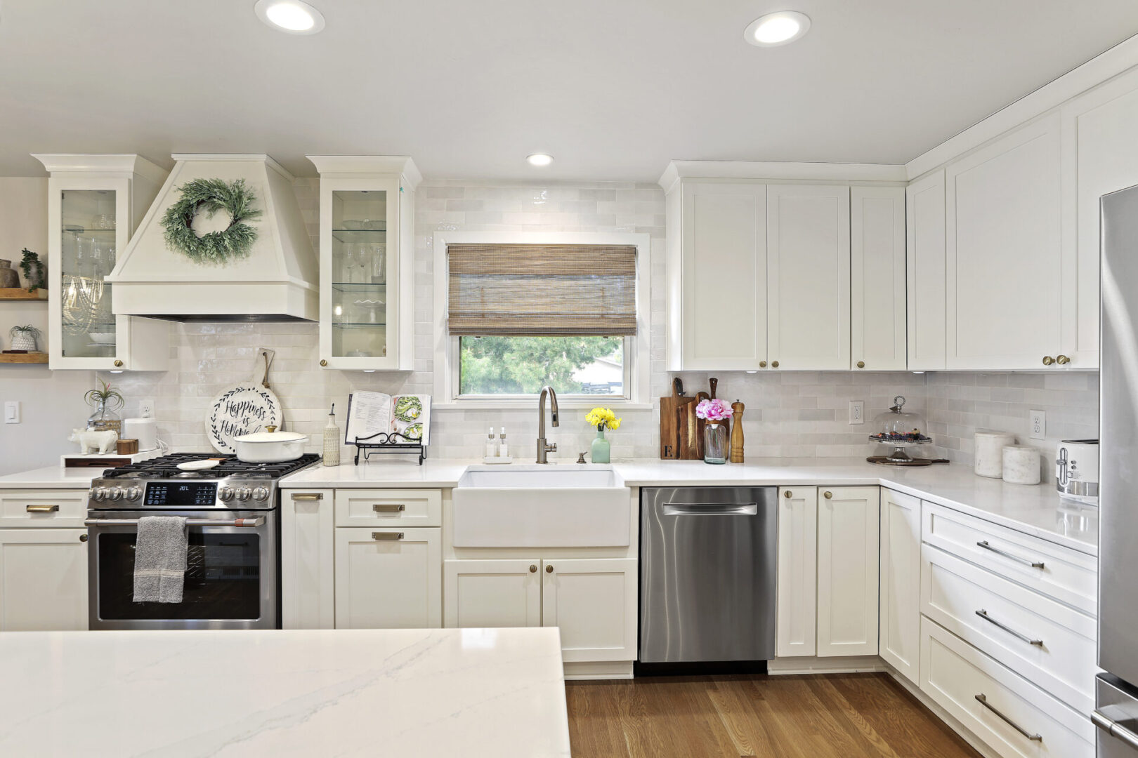 A kitchen with white cabinets and drawers