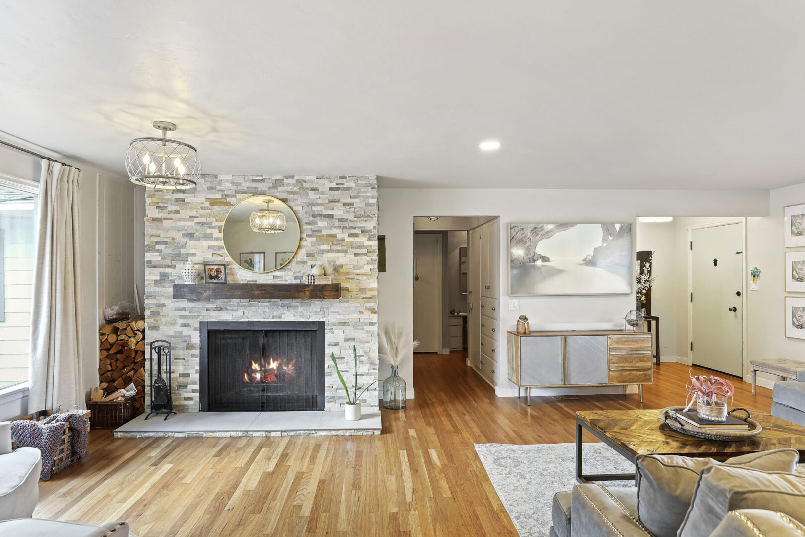 A living room with a fireplace and hardwood floors.