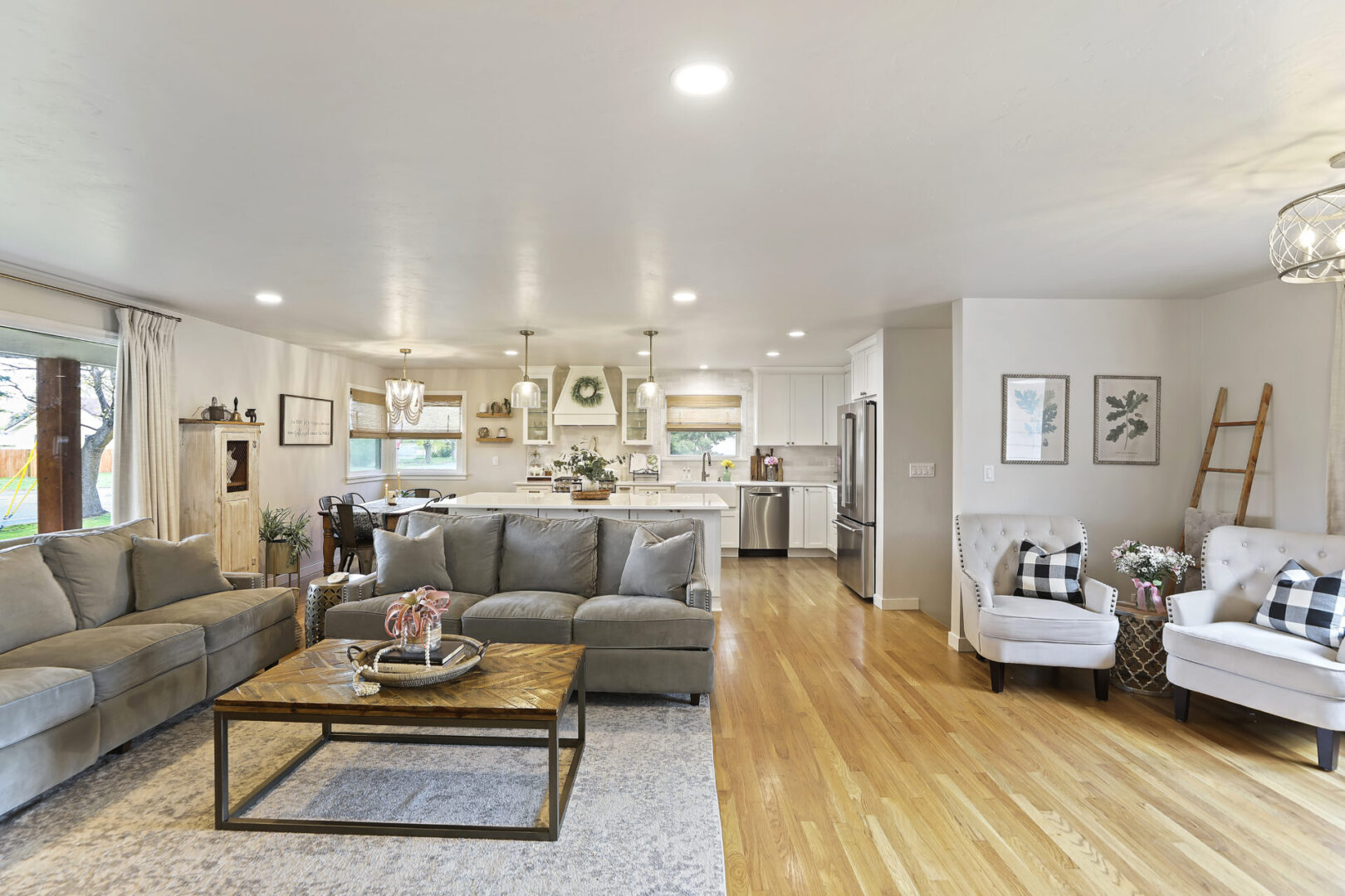 A living room with hard wood floors and furniture.